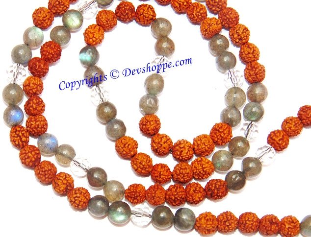 Layered view of orange rudraksha beads and grey labradorite beads on a mala strand