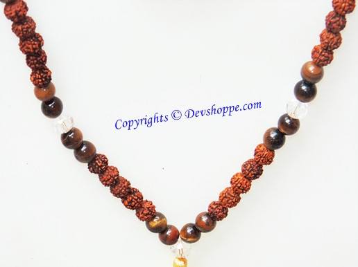 Bead mala in reddish rudraksha and dark tiger eye stones, laid in a U shape
