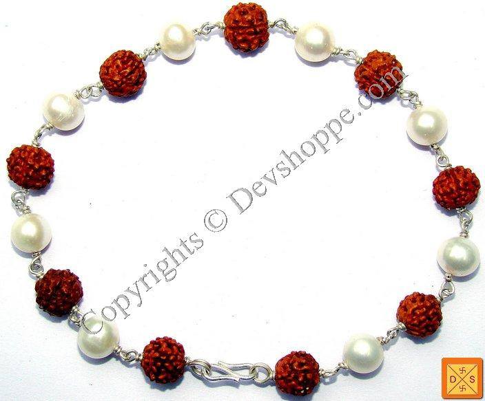 Rudraksha pearl bracelet with red bead charms, white pearls, and silver chain