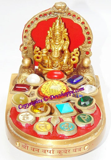 Kuber idol yantra chowki with red backplate and gold figure, gemstone pieces on base