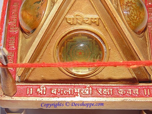Sri Baglamukhi Raksha Yantra Chowki close-up, gold triangle with circular center and Devanagari