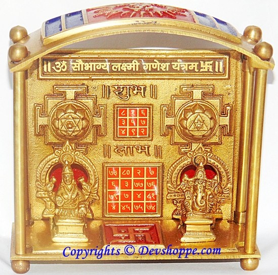 Brass Lakshmi Ganesha yantra chowki with arched frame and engraved deity figures