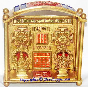 Brass Lakshmi Ganesha yantra chowki with arched frame and engraved deity figures