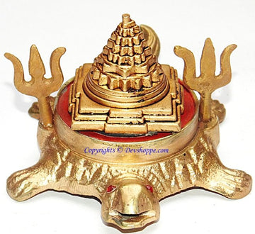 Brass Shri Yantra on tortoise base with red backplate and tall stacked cone top