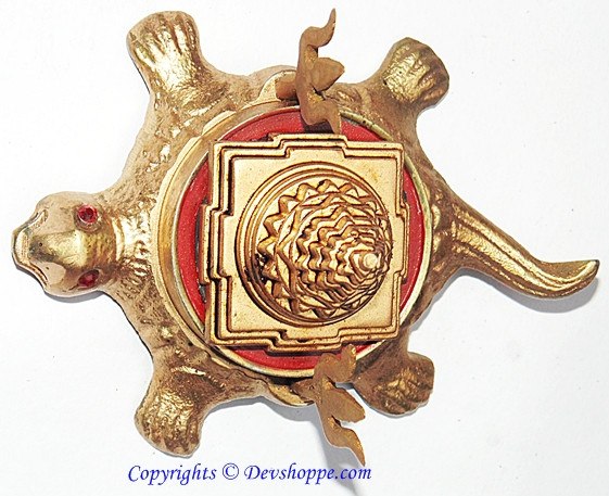 Brass tortoise figurine with round Shri Yantra medallion, red border, and gem eyes