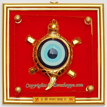 Tortoise evil-eye hanging yantra with circular blue eye and gold decorative frame