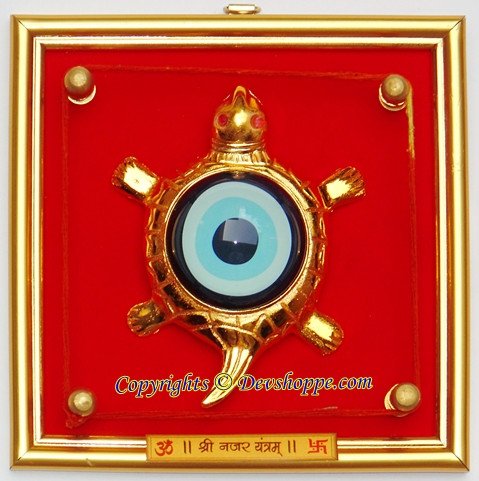 Tortoise evil-eye hanging yantra with circular blue eye and gold decorative frame