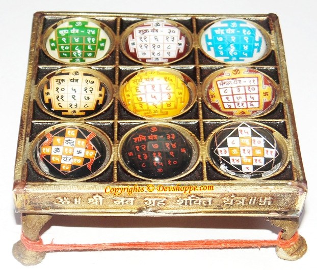 Brass yantra chowki with nine circular Navgraha tablets in multicolor